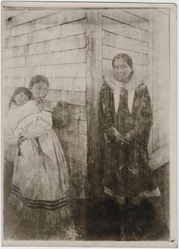 Netsillik-kvinne og en jente med et barn på ryggen